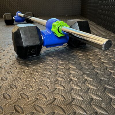 Blue dualbell holding a dumbbell attached to a barbell